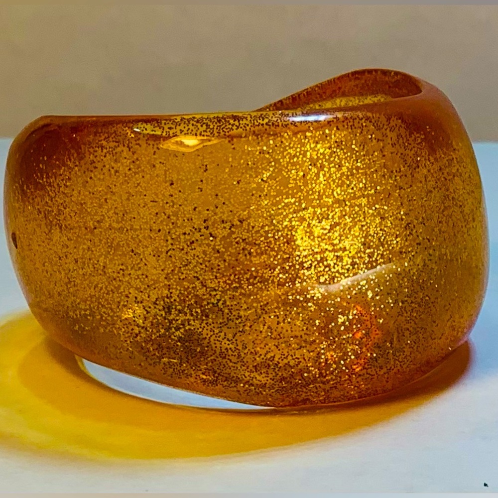 Amber sparkle lucite cuff bracelet. Roll back to 1970’s glitz and glam.